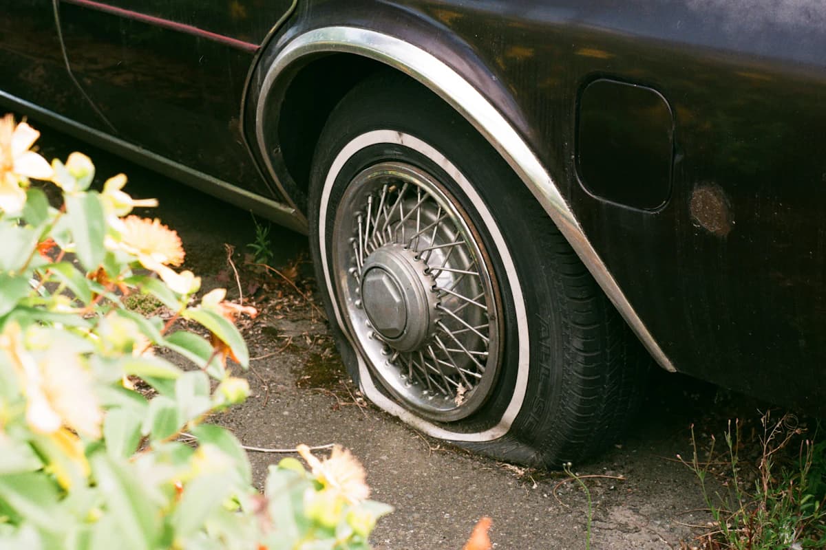 Car with a flat tyre waiting for a mobile tyre fitter
